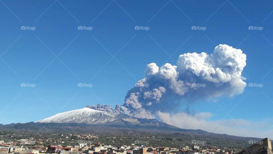 Etna volcano erupting and spewing ash, view from Adrano, Catalia