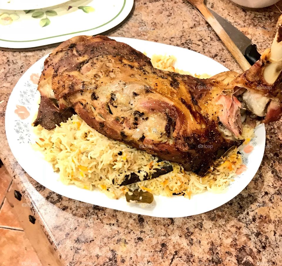 Half mandi or half plate rice with roasted lamb. Ingredients are rice, lamb, sunflower oil, butter, cardammon, chilli, pepper, curry leaf, turmeric, and salt. 