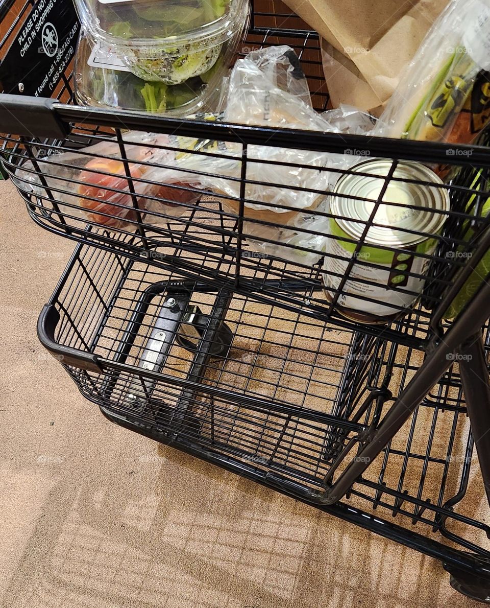 view of a black grocery cart full of fresh food in an Oregon market