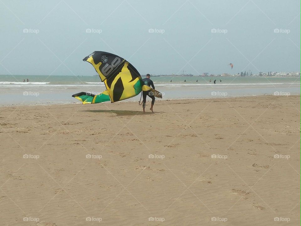 A surfer man in a trip near the beach at essaouira city in Morocco