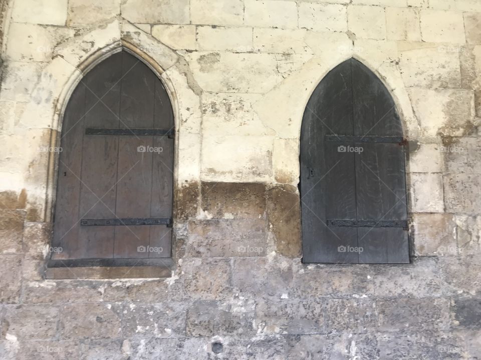 Shuttered windows at Norwich cathedral cloisters