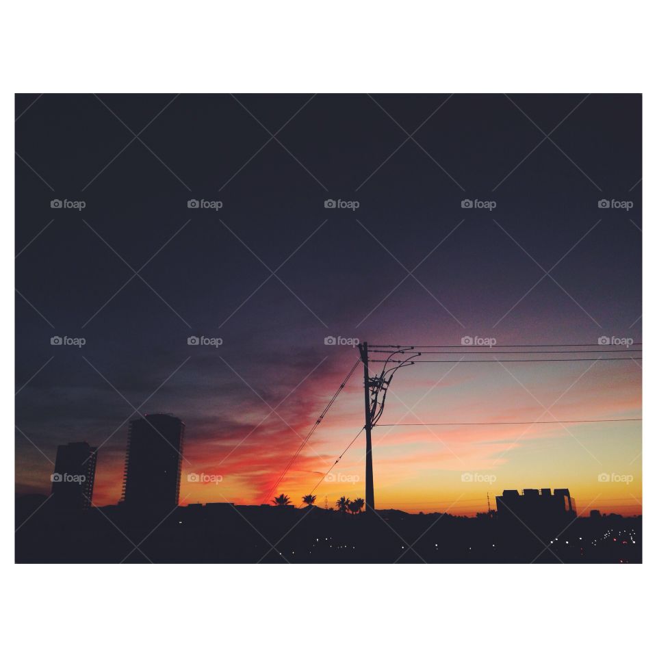 City at sunset. Power line silhouette at sunset 