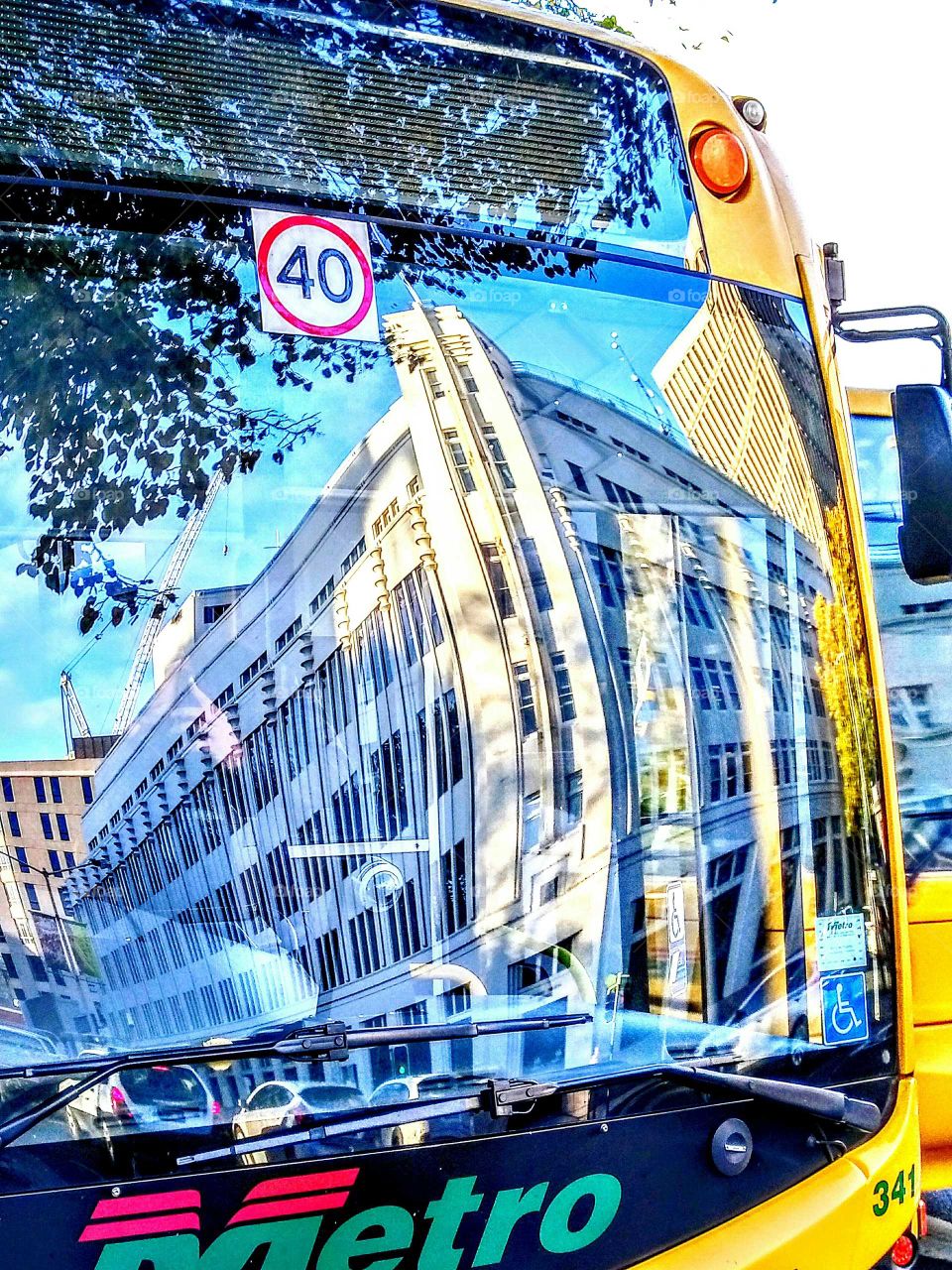 building reflection in bus window