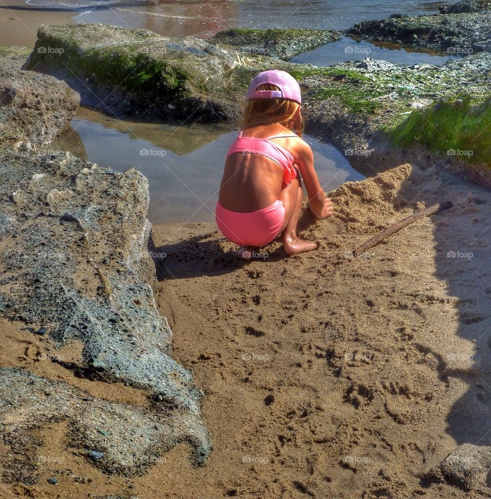 Girl playing at the beach 