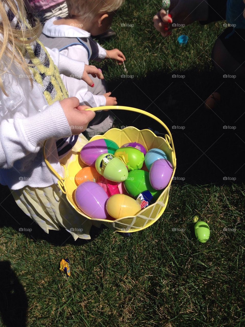 Kids collecting Easter eggs in their baskets