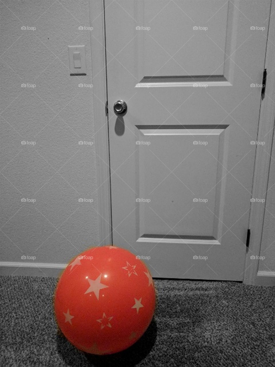 Red ball in black and white room