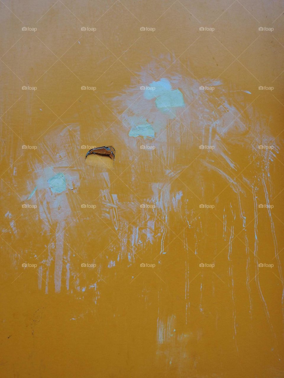 Yellow and light blue colors on a wall or a door in the city, abstract
