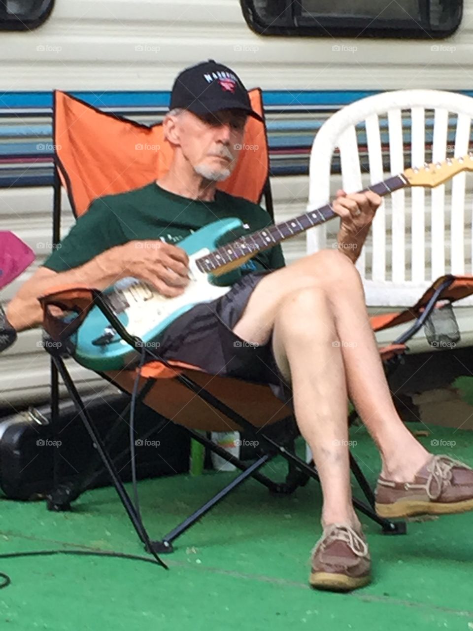 Senior man sitting with guitar
