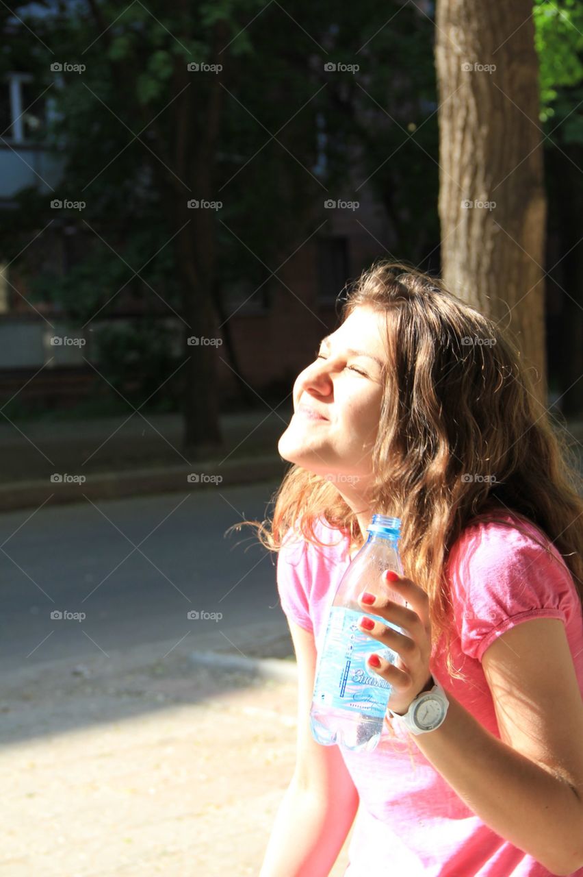Girl is enjoying spring. Girl is smiling and is enjoying spring at the sun