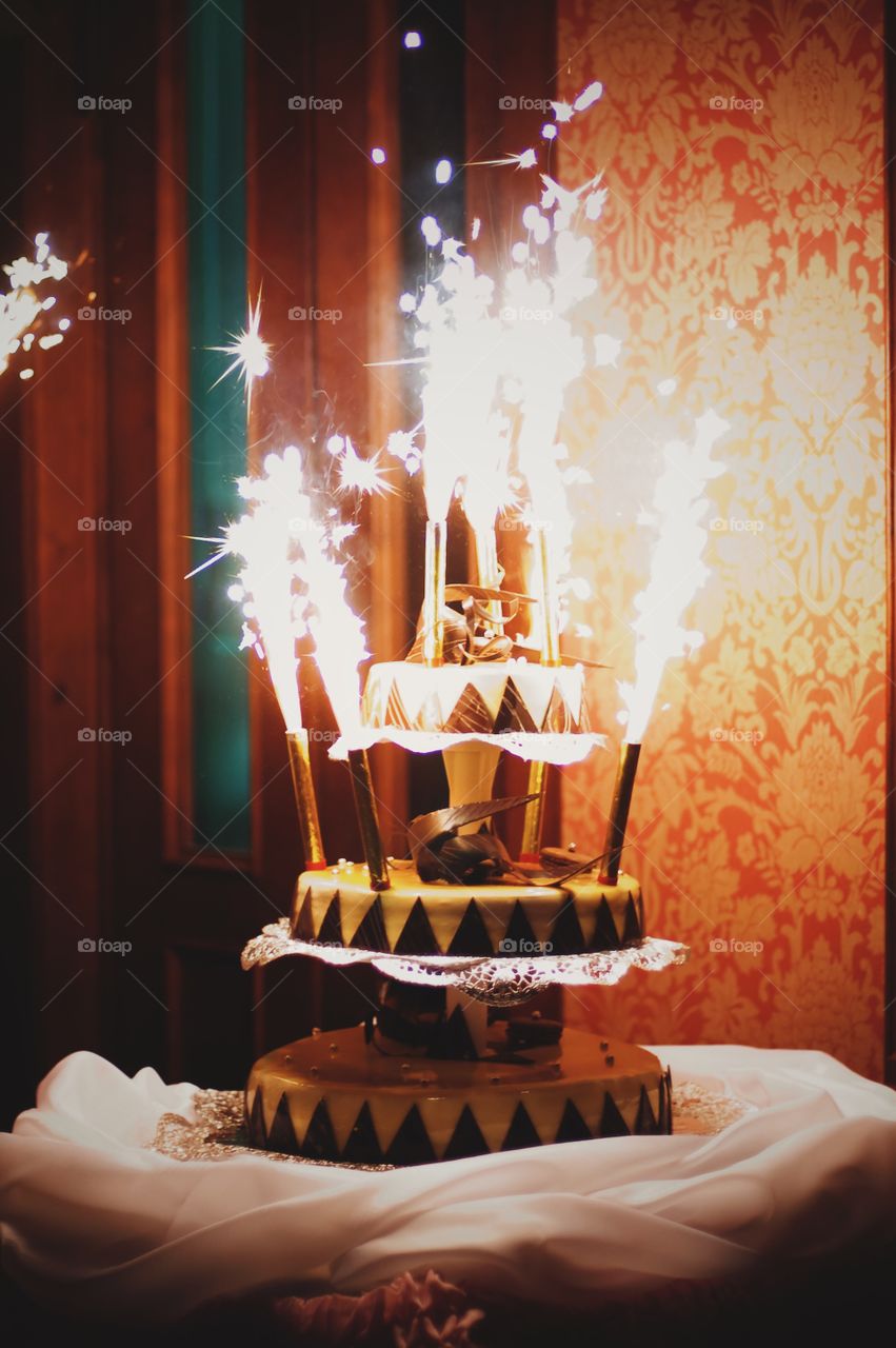 Illuminated candle with cake