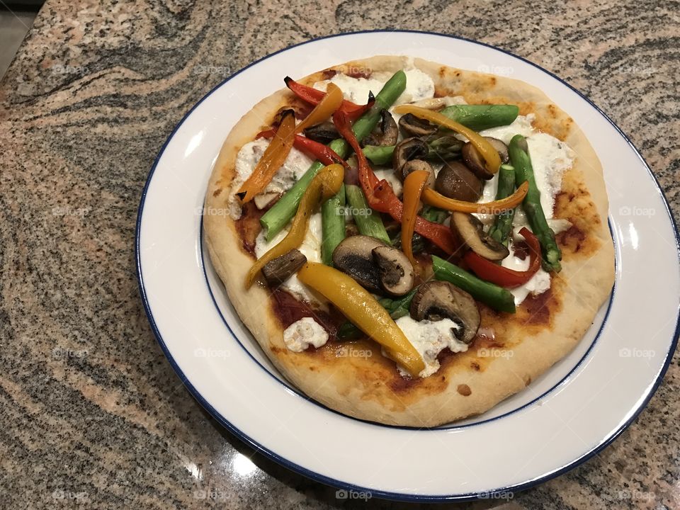 Pizza with vegetables and mozzarella cheese