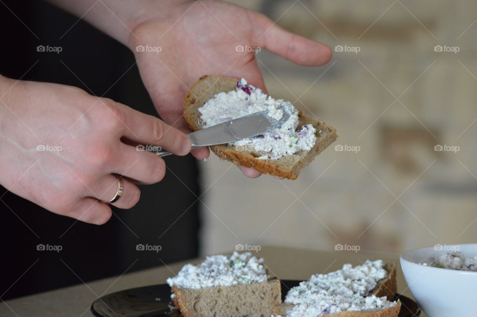 Healthy breakfast- white cottage cheese with onions, chives, salt and pepper on bread