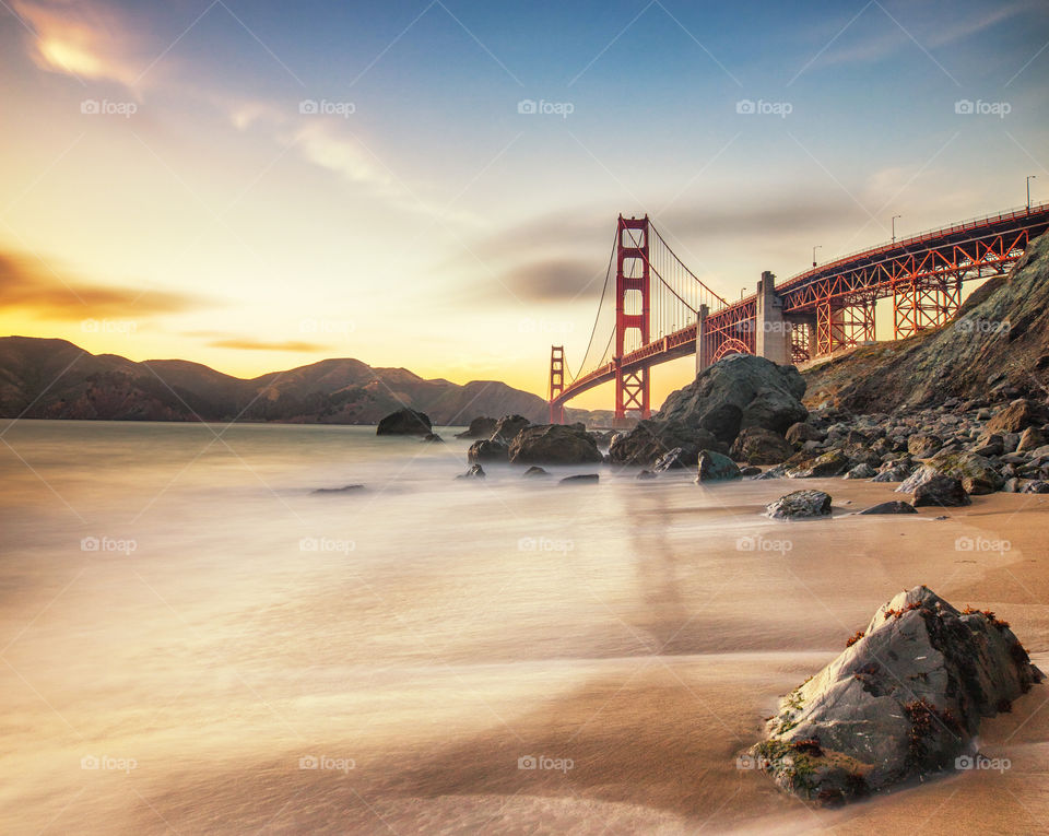 Golden sunset light in the Golden Gate Bridge from Marshall’s beach, San Francisco 