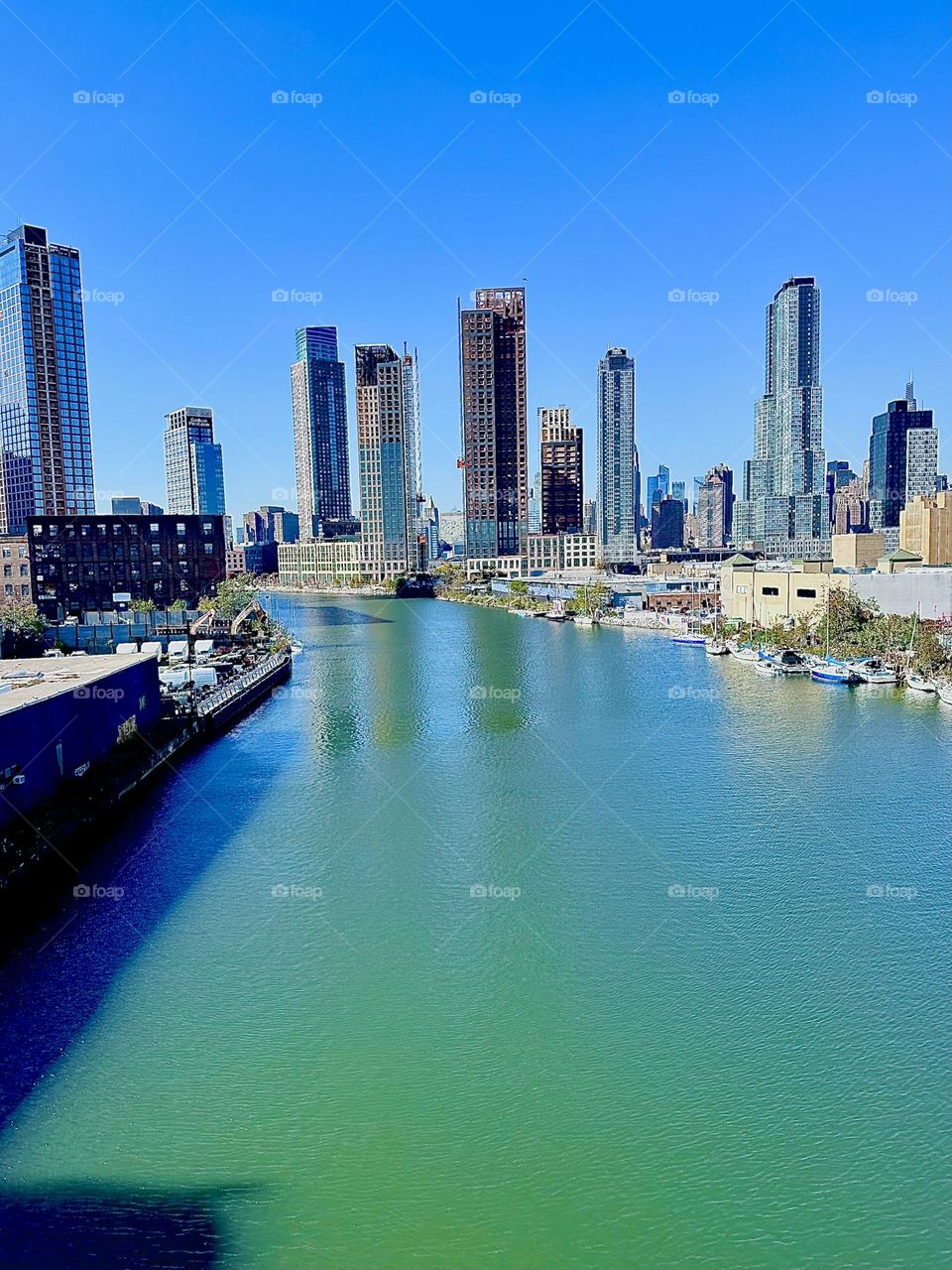 This is „Newtown Creek“, an ocean inlet of the „East River“ seen from the „Pulaski Bridge“ in LIC, Queens. The views from here are truly amazing from „Greenpoint“, Bklyn to the left to LIC and „Manhattan“ to the right. 2023. Hypnotic Productions