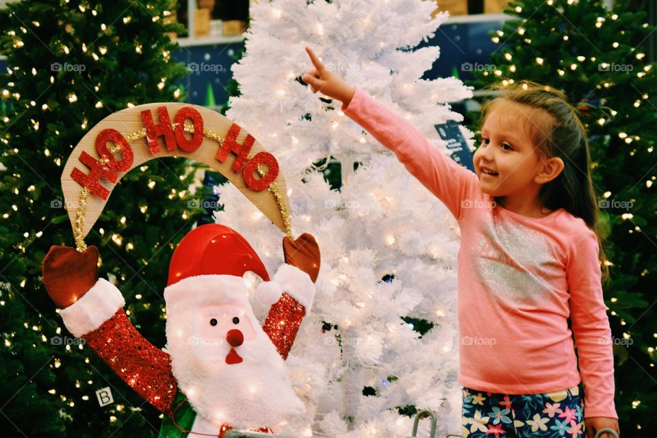 Girl showing christmas decoration