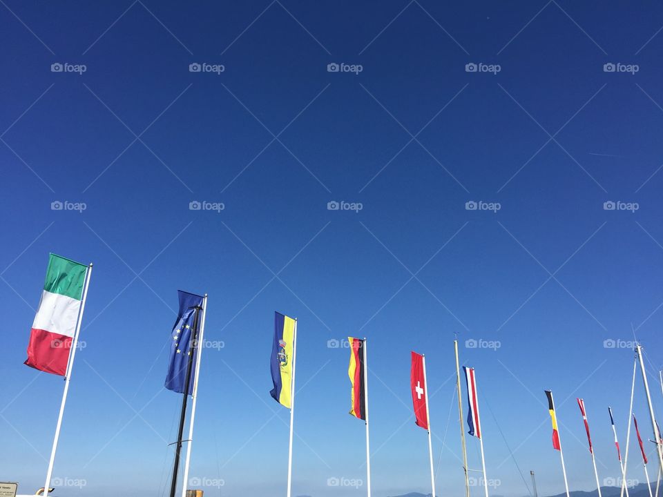 European flags at Lake Garda in front of a blue sky