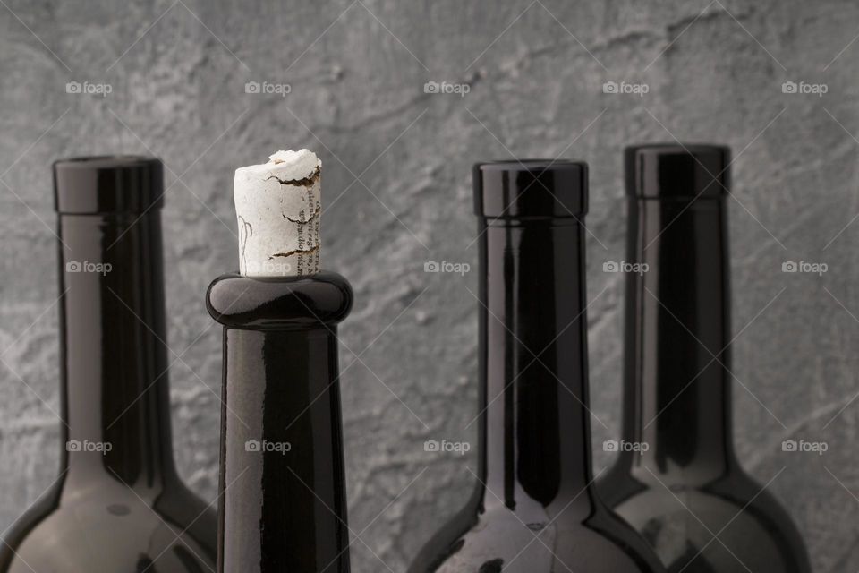 wine bottles against grey background