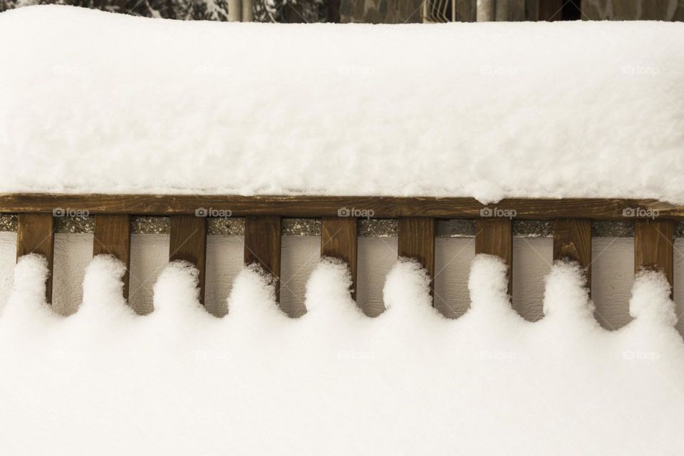 Fence covered with snow