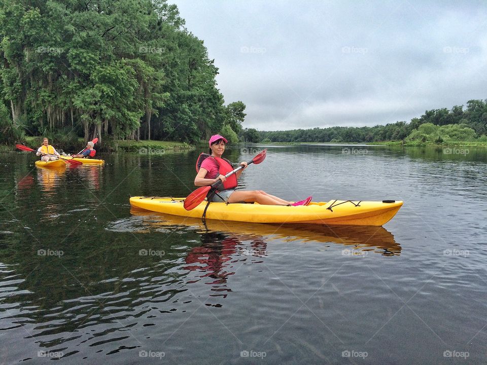 Woman kayaking in lake