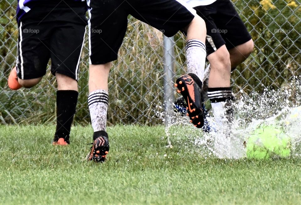 Soccer game on a very waterlogged field