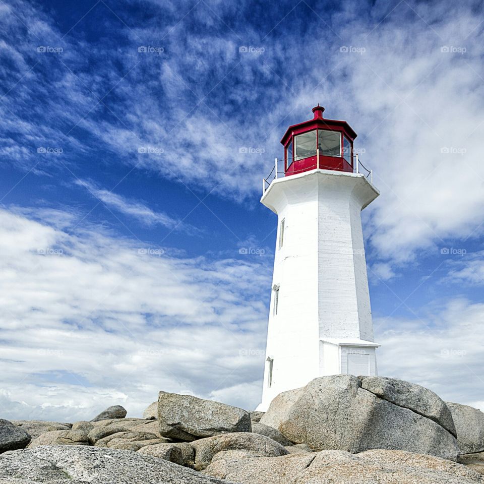 Lighthouse on Rocky point on sunny day