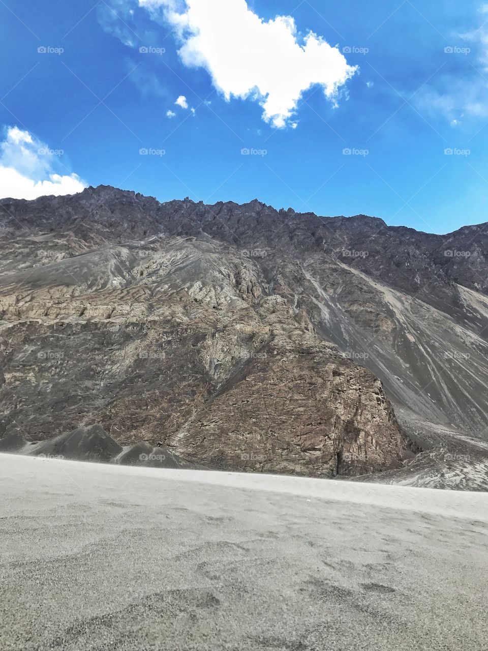 Contrast of sand desert and mountains