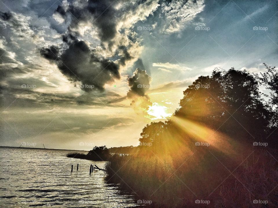 Intrigued. Sun Rays through heavy clouds