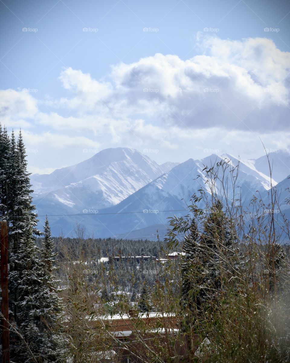 Snow covered mountains across a small town in the valley.