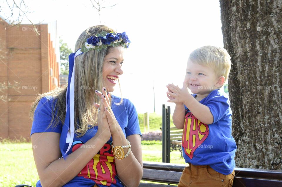 joy in the park mother and son playing and smiling