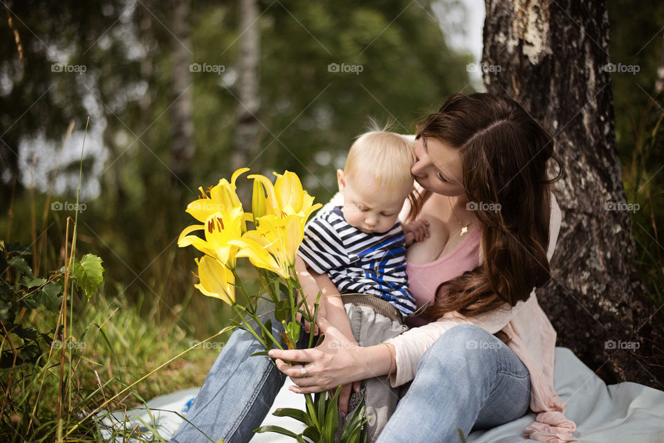 View of mother kissing child on forehead