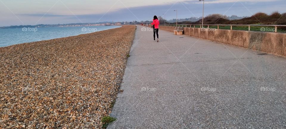 RUNNER RUNNING ALONG THE SEAFRONT WEYMOUTH DORSET