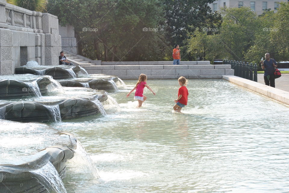 Kids playing in a fountain