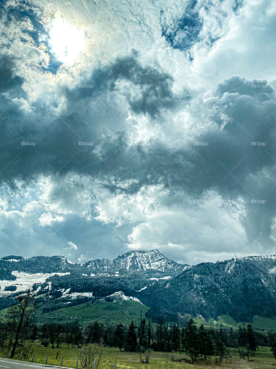 Swiss beauties, Swiss mountains, clouds floating over the Alps, railway, stop, bus, beautiful painted building, road
