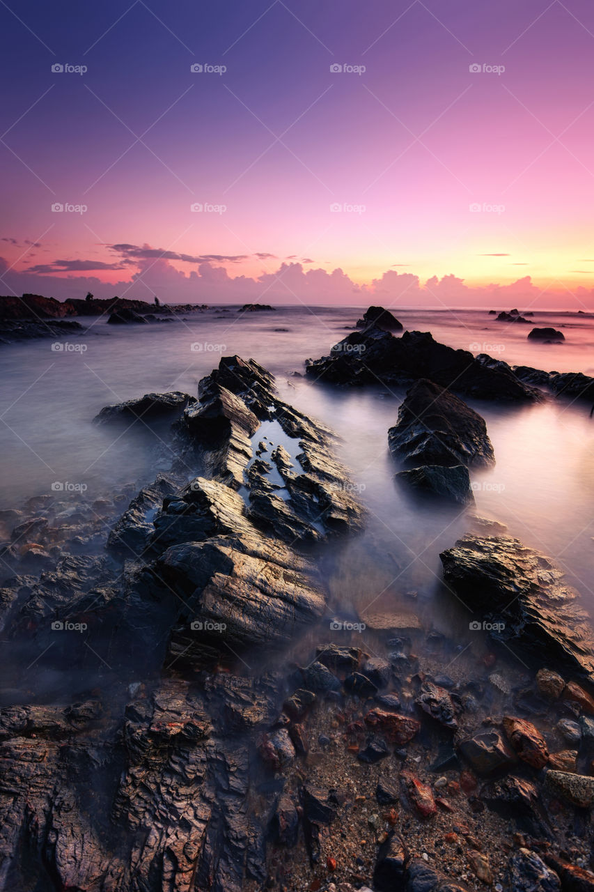 Sunset at the rocky beach