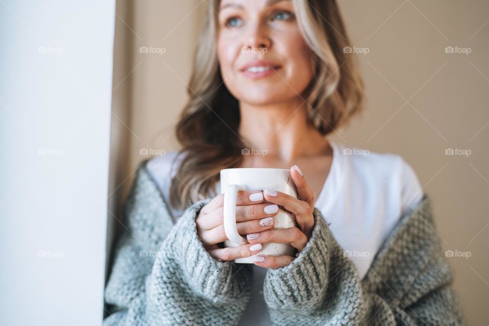 Blonde woman with tea at home