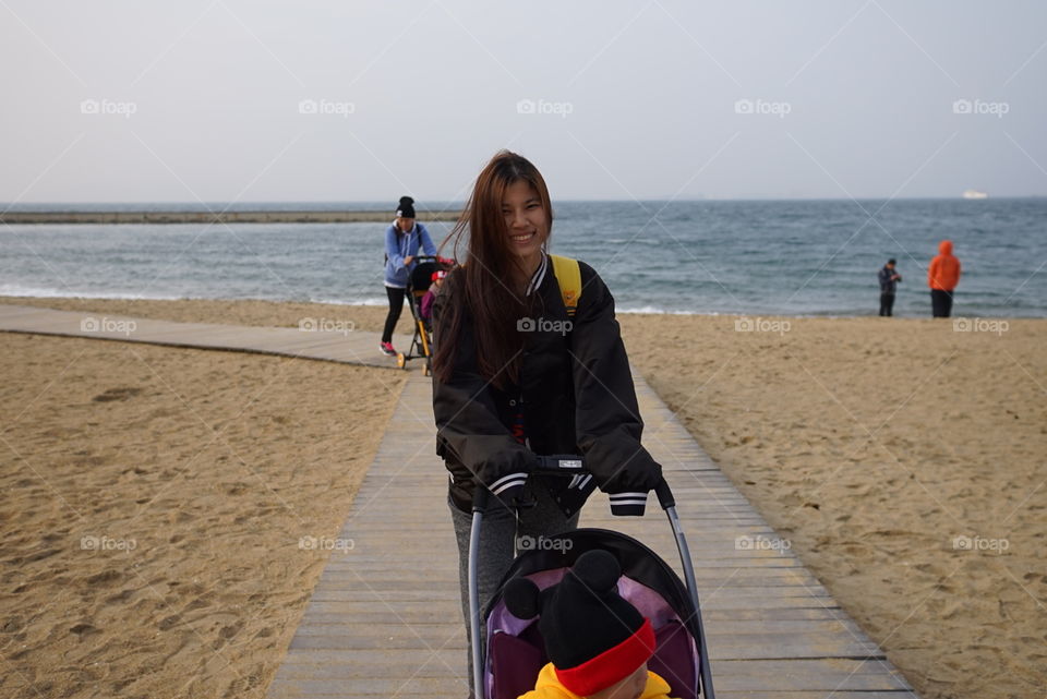 Japanese family walking the Fukuoka beach