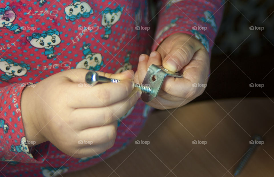 little girl holding tools