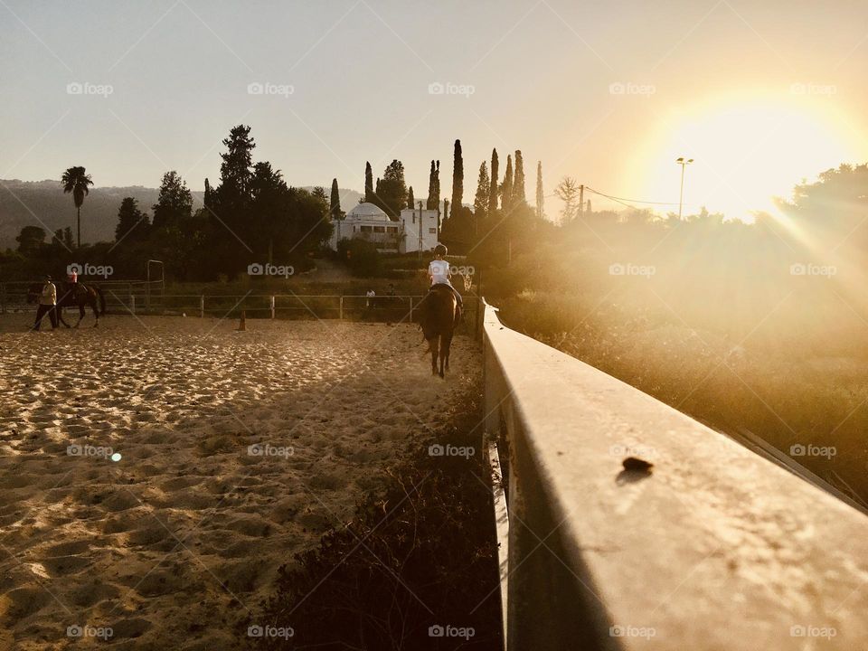 A boy rides into the sunset