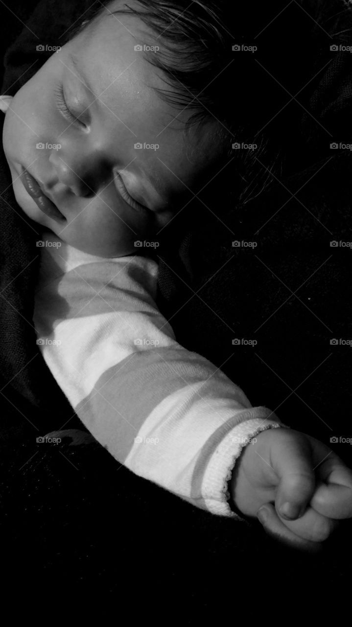 Cute boy sleeping on bed