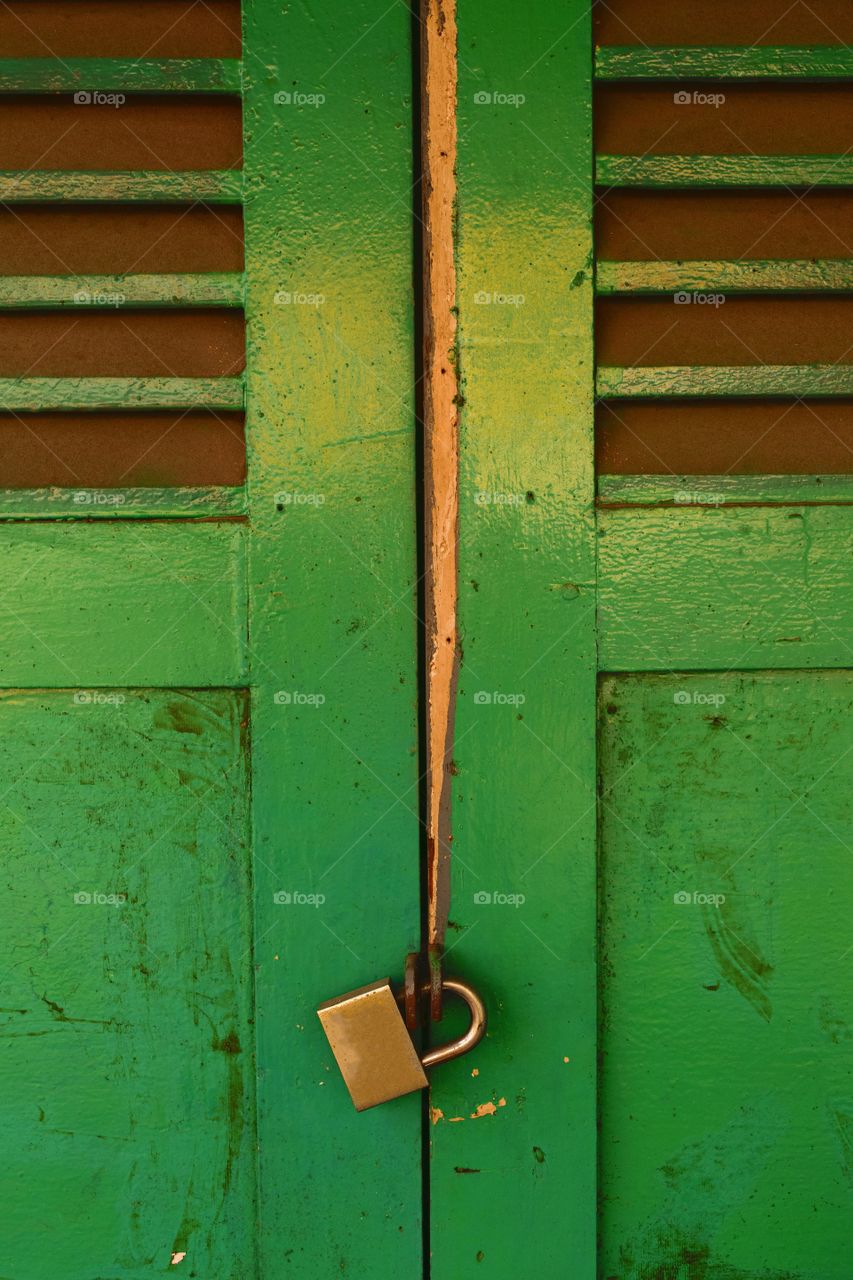 Close-up of lock on green door