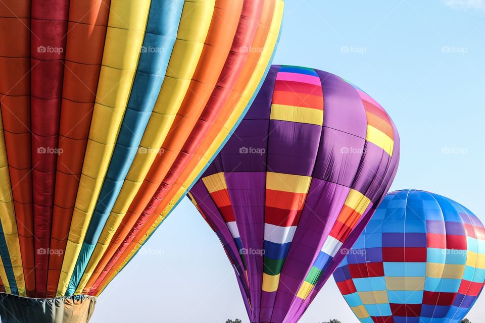 Colorful hot air balloons against blue sky