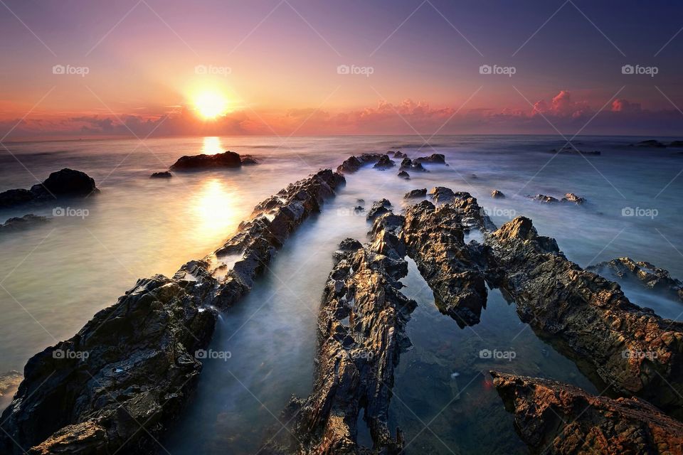 Beautiful sunset over the rocky beach in Terengganu, Malaysia