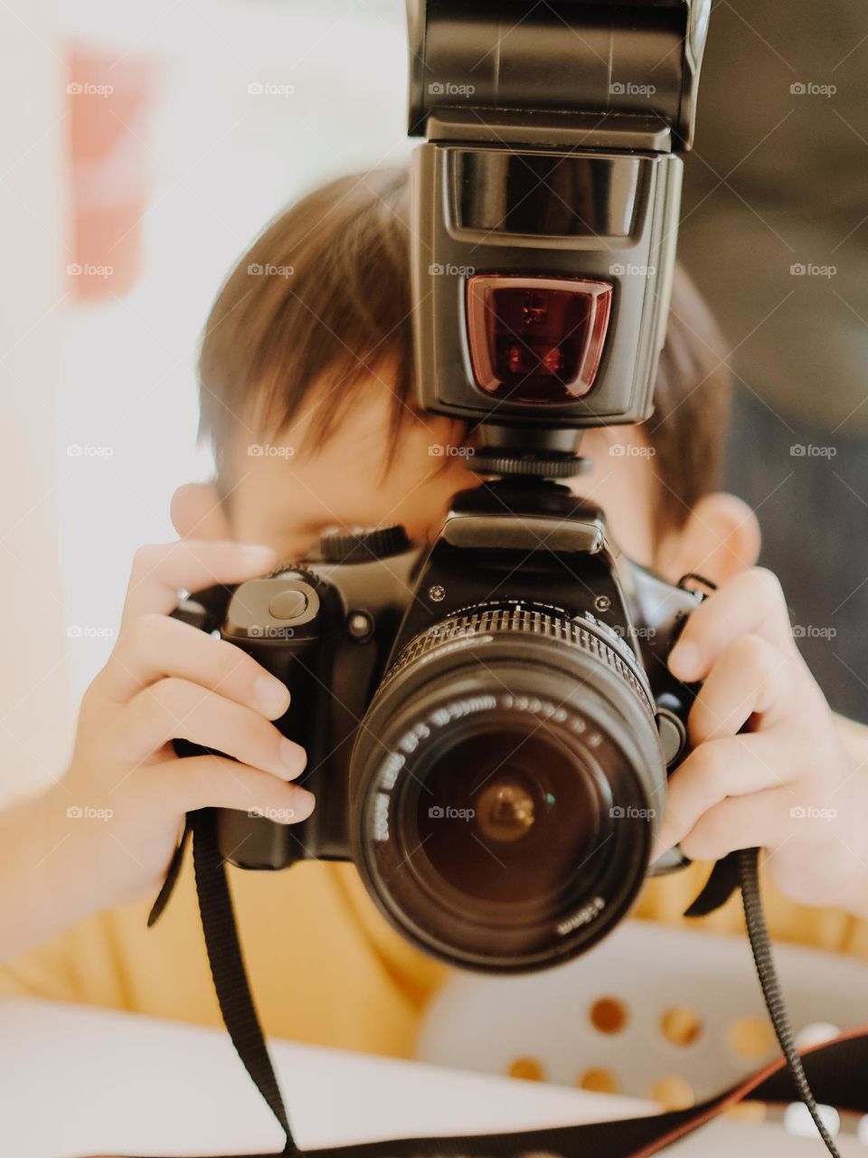 Young boy getting to know a camera