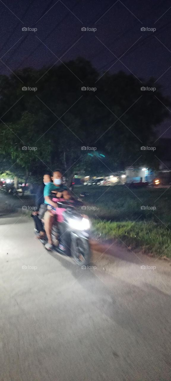 Riding The Motor With Family At The Night