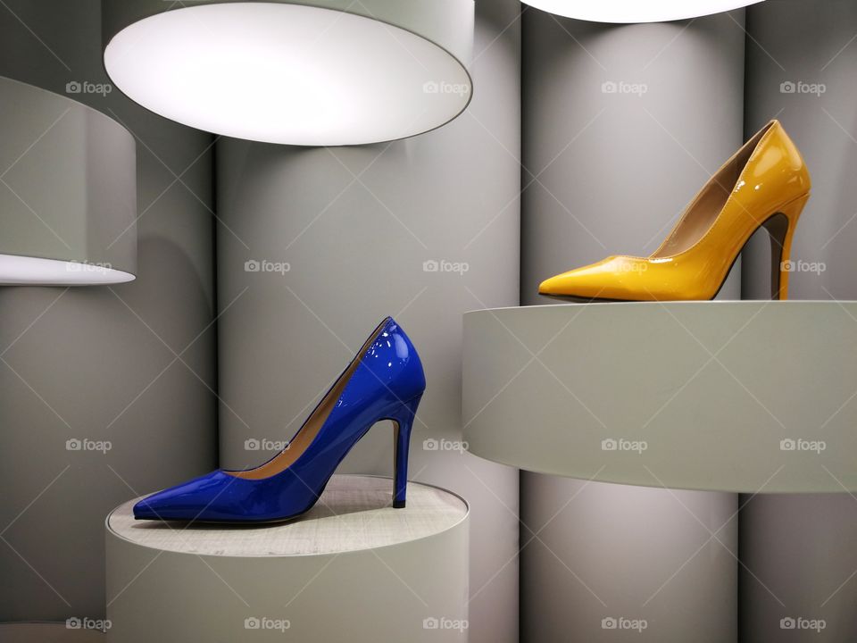 Stylish colourful high heels on modern display