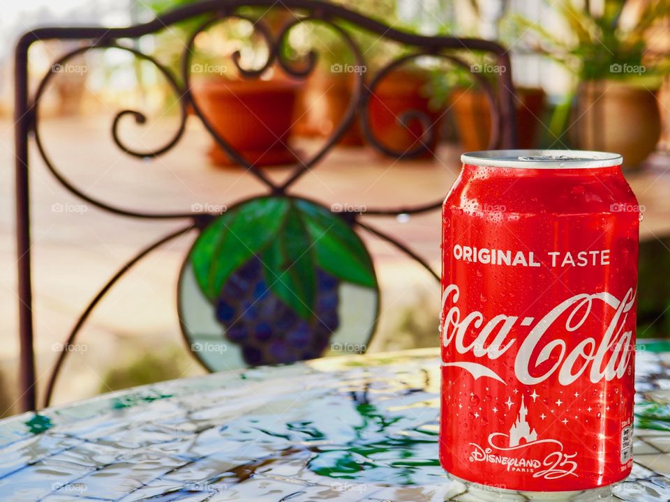 Coca cola can on garden table.