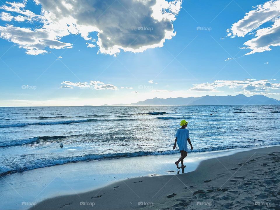 Woman take a walk on the beach 