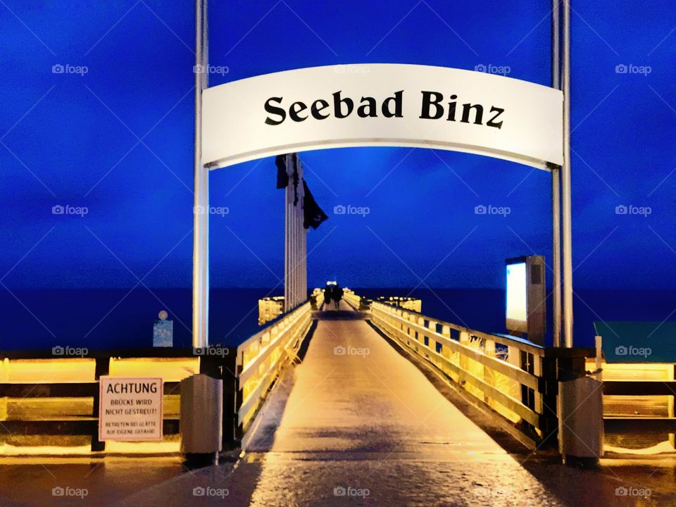 romantic evening at the pier in Binz on the island of Rügen. Fantastic blue of the sky and bright yellow of the lamps.