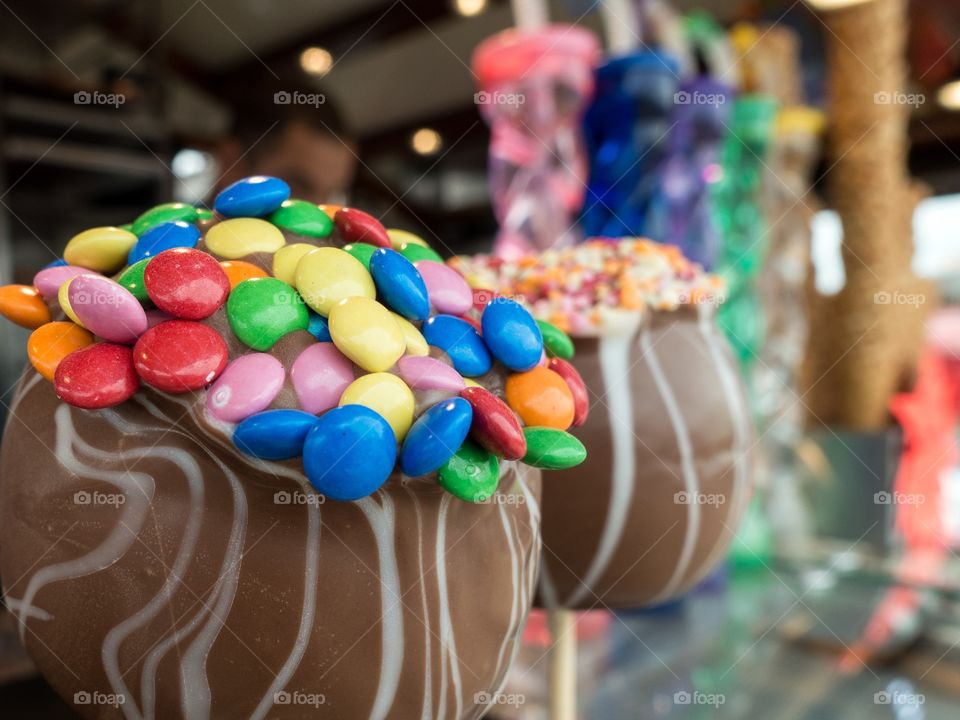 Icecream on a stand with colorful candy and chocolatetopping