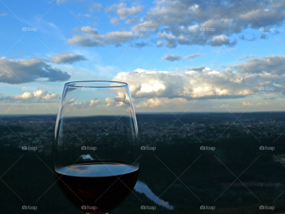 A glass of wine against Vilnius' panorama